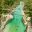 A suspension bridge spans the emerald waters of the Soca River in Slovenia